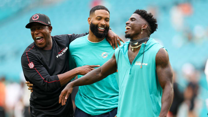 Atlanta Falcons head coach Raheem Morris greets Miami Dolphins wide receiver Odell Beckham Jr. (3) and wide receiver Tyreek Hill (10) during warmups for a preseason game at Hard Rock Stadium. 