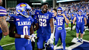 Kansas Jayhawks players celebrate their victor after the game between Fresno State and Kansas at David Booth Kansas Memorial Stadium on Aug. 23, 2025.