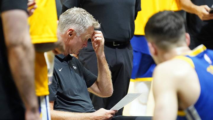Oct 4, 2026; Honolulu, Hawaii, USA;  Golden State Warriors head coach Steve Kerr reviews notes on the bench during the fourth quarter at Bankoh Arena at the Stan Sheriff Center.  Mandatory Credit: Michelle Bir-Imagn Images