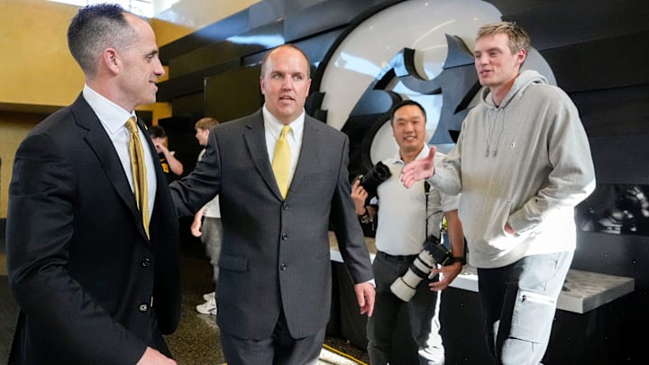Peyton Sandfort greets Iowa's new head men's basketball coach Ben McCollum after his introductory press conference Tuesday, March 25, 2025 at Carver-Hawkeye Arena in Iowa City, Iowa.