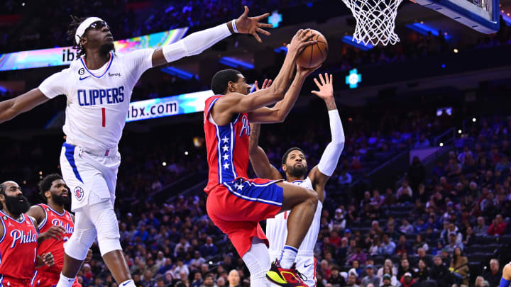 Dec 23, 2022; Philadelphia, Pennsylvania, USA; Philadelphia 76ers guard De'Anthony Melton (8) shoots against Los Angeles Clippers guard Reggie Jackson (1) and forward Paul George (13) in the first quarter at Wells Fargo Center. Mandatory Credit: Kyle Ross-USA TODAY Sports