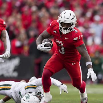 Oct 25, 2025; Cincinnati, Ohio, USA;  Cincinnati Bearcats running back Tawee Walker (3) runs with the ball after breaking a tackle against Baylor Bears safety Tyler Turner (17) in the first half at Nippert Stadium. Mandatory Credit: Aaron Doster-Imagn Images