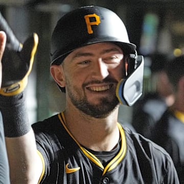 Pittsburgh Pirates third baseman Jared Triolo (19) is greeted by teammates after hitting a three-run home run against the Chicago Cubs during the seventh inning at Wrigley Field. 