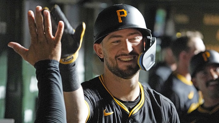 Pittsburgh Pirates third baseman Jared Triolo (19) is greeted by teammates after hitting a three-run home run against the Chicago Cubs during the seventh inning at Wrigley Field. 