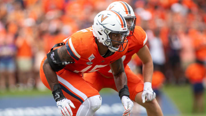 September 9, 22023 in Charlottesville, Virginia; Virginia Cavaliers defensive end Chico Bennett Jr. (15) keeps his eye on the ball while James Madison initiates a play against in the first half of the game at Scott Stadium.  Mandatory Credit: Hannah Pajewski-USA TODAY Sports