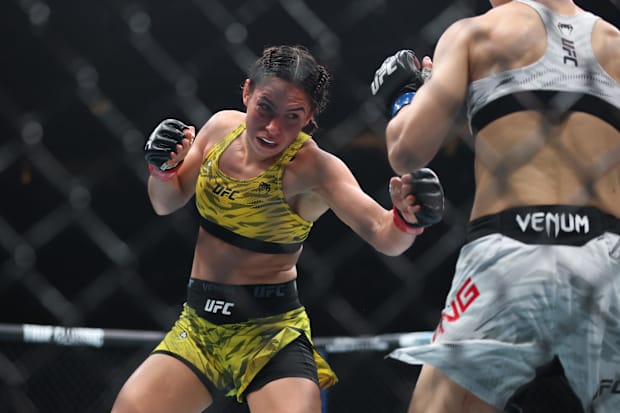 Ariane Da Silva (red gloves) fights Wang Cong (blue gloves) during UFC 316 at Prudential Center.