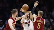 Nov 10, 2025; Miami, Florida, USA;  Cleveland Cavaliers forward Dean Wade (32) and guard Sam Merrill (5) defend Miami Heat forward Jaime Jaquez Jr. (11) during the second half at Kaseya Center. Mandatory Credit: Rhona Wise-Imagn Images