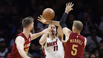 Nov 10, 2025; Miami, Florida, USA;  Cleveland Cavaliers forward Dean Wade (32) and guard Sam Merrill (5) defend Miami Heat forward Jaime Jaquez Jr. (11) during the second half at Kaseya Center. Mandatory Credit: Rhona Wise-Imagn Images