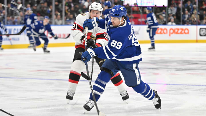 Nov 8, 2023; Toronto, Ontario, CAN; Toronto Maple Leafs forward Nick Robertson (89) shoots the puck past Ottawa Senators forward Vladimir Tarasenko (91) in the third period at Scotiabank Arena. Mandatory Credit: Dan Hamilton-USA TODAY Sports