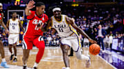 Feb 8, 2025; Baton Rouge, Louisiana, USA;  LSU Tigers forward Corey Chest (11) dribbles against Mississippi Rebels guard Matthew Murrell (11) during the first half at Pete Maravich Assembly Center. Mandatory Credit: Stephen Lew-Imagn Images