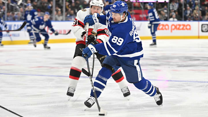 Nov 8, 2023; Toronto, Ontario, CAN; Toronto Maple Leafs forward Nick Robertson (89) shoots the puck past Ottawa Senators forward Vladimir Tarasenko (91) in the third period at Scotiabank Arena. Mandatory Credit: Dan Hamilton-Imagn Images