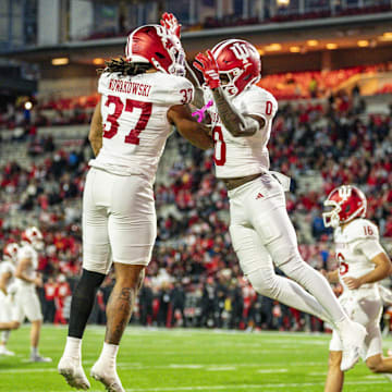 Nov 1, 2025; College Park, Maryland, USA;  Indiana Hoosiers wide receiver Jonathan Brady (0) celebrates with former Wisconsin Badgers tight end Riley Nowakowski (37) after scoring a touchdown