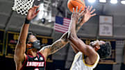 Feb 16, 2025; South Bend, Indiana, USA; Notre Dame Fighting Irish guard Brady Stevens (0) is fouled by Louisville Cardinals forward James Scott (0) in the first half at the Purcell Pavilion. Mandatory Credit: Matt Cashore-Imagn Images