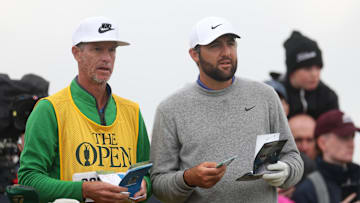 Scottie Scheffler talks to his caddie Ted Scott on the 15th hole during The 153rd Open Championship golf tournament