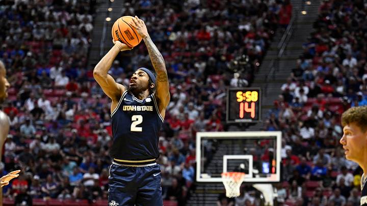 Mar 22, 2026; San Diego, CA, USA; Utah State Aggies guard Mj Collins (2) shoots against the Arizona Wildcats in the first half during a second round game of the men's 2026 NCAA Tournament at Viejas Arena. Mandatory Credit: Denis Poroy-Imagn Images