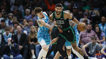 Nov 2, 2024; Charlotte, North Carolina, USA; Boston Celtics forward Jayson Tatum (0) collides with Charlotte Hornets guard LaMelo Ball (1) during the second half at Spectrum Center. Mandatory Credit: Nell Redmond-Imagn Images