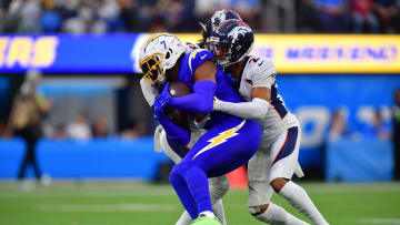 Gerald Everett tries to pull free of a tackle attempt by Patrick Surtain II in a Chargers game last season. Everett will not be available for the first Bears practices due to injury.