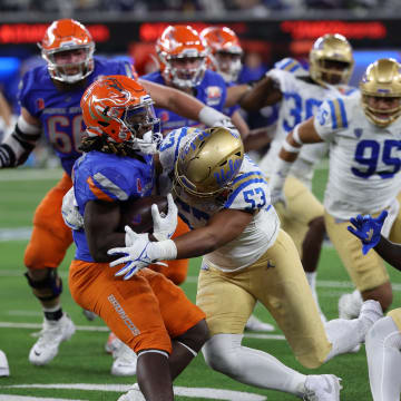 iDec 16, 2023; Inglewood, CA, USA; UCLA Bruins linebacker Darius Muasau (53) tackles Boise State Broncos running back Ashton Jeanty (2) during the third quarter of the LA Bowl at SoFi Stadium. Mandatory Credit: Kiyoshi Mio-USA TODAY Sports