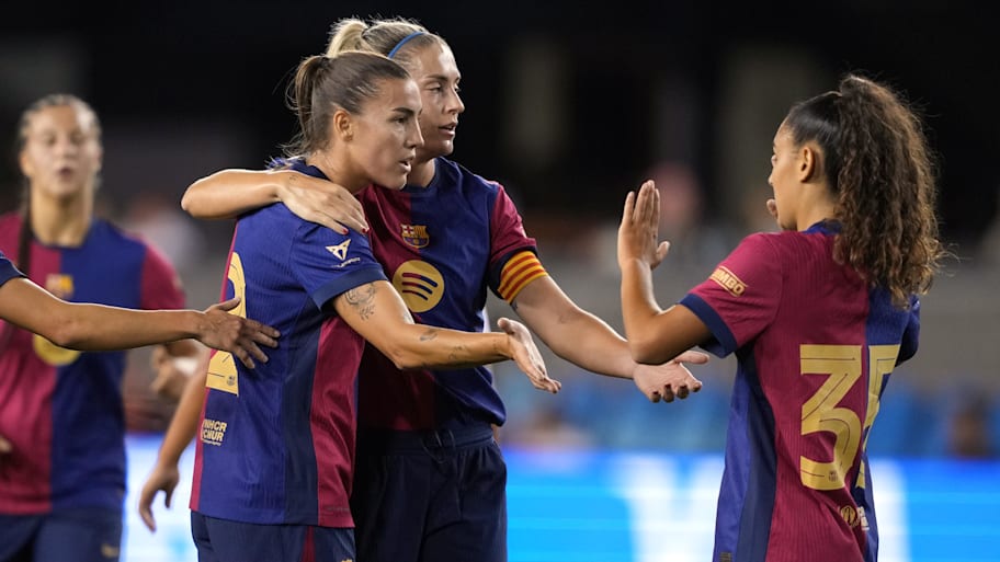 FC Barcelona midfielder Patri Guijarro is congratulated by midfielder Alexia Putellas