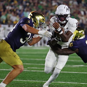 Texas A&M Aggies quarterback Marcel Reed (10) runs the ball as Notre Dame Fighting Irish safety Adon Shuler (8) goes for a tackle during the second half at Notre Dame Stadium. Credit: Trevor Ruszkowski-Imagn Images