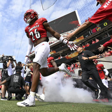 Sep 24, 2022; Louisville, Kentucky, USA; Louisville Cardinals safety M.J. Griffin (26) leads the team to the field before the first quarter against the South Florida Bulls at Cardinal Stadium. 