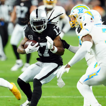 Dec 14, 2023; Paradise, Nevada, USA; Las Vegas Raiders wide receiver Davante Adams (17) runs against Los Angeles Chargers safety Alohi Gilman (32) and safety Derwin James Jr. (3) in the first quarter at Allegiant Stadium. Mandatory Credit: Stephen R. Sylvanie-USA TODAY Sports