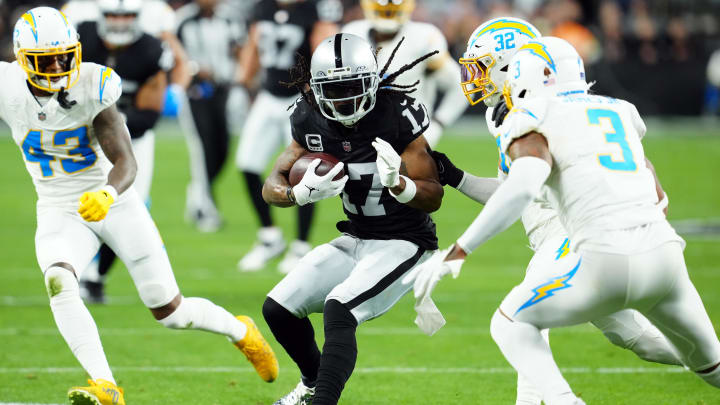 Dec 14, 2023; Paradise, Nevada, USA; Las Vegas Raiders wide receiver Davante Adams (17) runs against Los Angeles Chargers safety Alohi Gilman (32) and safety Derwin James Jr. (3) in the first quarter at Allegiant Stadium. Mandatory Credit: Stephen R. Sylvanie-USA TODAY Sports