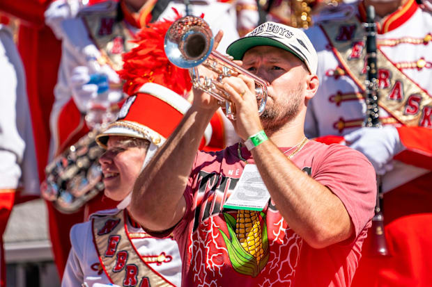 Former Nebraska Cornhuskers linebacker and NFL free agent Will Compton holds a trumpet with the Cornhusker Marching Band.