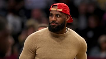 Mar 10, 2025; Brooklyn, New York, USA; Los Angeles Lakers injured forward LeBron James (23) on the court during a time out during the first quarter against the Brooklyn Nets at Barclays Center. Mandatory Credit: Brad Penner-Imagn Images