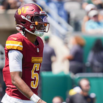 Aug 10, 2024; East Rutherford, New Jersey, USA; Washington Commanders quarterback Jayden Daniels (5) competes during the first half against the New York Jets at MetLife Stadium. Mandatory Credit: Lucas Boland-Imagn Images