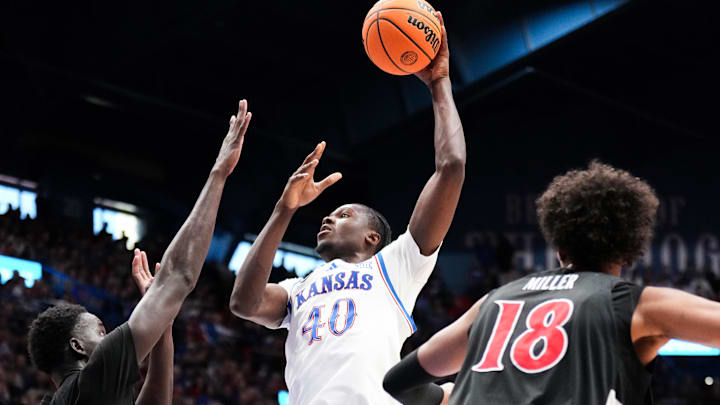 Feb 21, 2026; Lawrence, Kansas, USA; Kansas Jayhawks forward Flory Bidunga (40) shoots over Cincinnati Bearcats center Moustapha Thiam (52) during the first half of the game at Allen Fieldhouse. Mandatory Credit: Denny Medley-Imagn Images