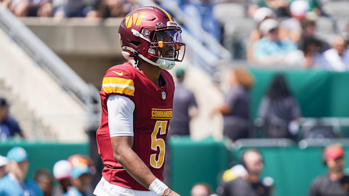 Aug 10, 2024; East Rutherford, New Jersey, USA; Washington Commanders quarterback Jayden Daniels (5) competes during the first half against the New York Jets at MetLife Stadium. Mandatory Credit: Lucas Boland-Imagn Images