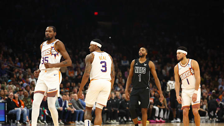 Dec 13, 2023; Phoenix, Arizona, USA; Phoenix Suns guard Bradley Beal (3), guard Devin Booker (1) and forward Kevin Durant (35) against Brooklyn Nets forward Mikal Bridges (1) at Footprint Center. Mandatory Credit: Mark J. Rebilas-Imagn Images