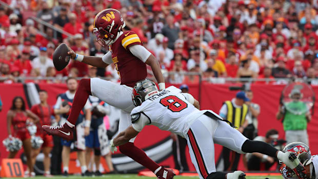 Washington Commanders quarterback Jayden Daniels scores a touchdown in Week 1.