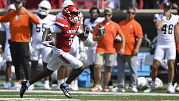 Sep 20, 2025; Louisville, Kentucky, USA;  Louisville Cardinals wide receiver Caullin Lacy (5) runs the ball for a touchdown against the Bowling Green Falcons during the first half at L&N Federal Credit Union Stadium. Mandatory Credit: Jamie Rhodes-Imagn Images