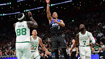 Nov 23, 2025; Boston, Massachusetts, USA;  Orlando Magic guard Desmond Bane (3) shoots the ball while Boston Celtics center Neemias Queta (88), guard Jordan Walsh (27) and guard Jaylen Brown (7) look on during the first half at TD Garden. Mandatory Credit: Bob DeChiara-Imagn Images
