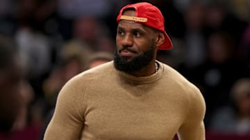 Mar 10, 2025; Brooklyn, New York, USA; Los Angeles Lakers injured forward LeBron James (23) on the court during a time out during the first quarter against the Brooklyn Nets at Barclays Center. Mandatory Credit: Brad Penner-Imagn Images