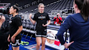 Former Iowa Hawkeyes Las Vegas Aces guard Kate Martin (20) and Indiana Fever guard Caitlin Clark (22) reunite Wednesday, Sept. 11, 2024, during a game between the Indiana Fever and the Las Vegas Aces at Gainbridge Fieldhouse in Indianapolis.