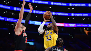 Jan 25, 2024; Los Angeles, California, USA; Los Angeles Lakers forward LeBron James (23) moves to the basket against Chicago Bulls center Nikola Vucevic (9) and forward DeMar DeRozan (11) : Gary A. Vasquez-Imagn Images
