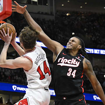 Apr 4, 2025; Chicago, Illinois, USA;  Chicago Bulls forward Matas Buzelis (14) shoots against Portland Trail Blazers forward Jabari Walker (34) during the second half at the United Center. Mandatory Credit: Matt Marton-Imagn Images