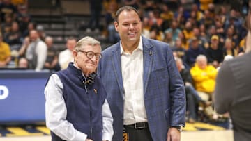 Dec 18, 2022; Morgantown, West Virginia, USA; West Virginia University President Gordon Gee welcomes new West Virginia Mountaineers Athletic Director Wren Baker during the first half against the Buffalo Bulls at WVU Coliseum. Mandatory Credit: Ben Queen-Imagn Images