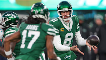 Jan 5, 2025; East Rutherford, New Jersey, USA; New York Jets quarterback Aaron Rodgers (8) pitches the ball to wide receiver Davante Adams (17) during the first quarter against the Miami Dolphins at MetLife Stadium. Mandatory Credit: Vincent Carchietta-Imagn Images