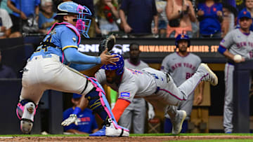 Aug 8, 2025; Milwaukee, Wisconsin, USA;  New York Mets designated hitter Starling Marte (6) tries to score but is tagged out by Milwaukee Brewers catcher William Contreras (24) in the ninth inning at American Family Field. Mandatory Credit: Benny Sieu-Imagn Images