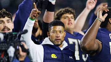 Notre Dame head coach Marcus Freeman celebrates with his players after winning a NCAA football game 70-7 against Syracuse at Notre Dame Stadium on Saturday, Nov. 22, 2025, in South Bend.