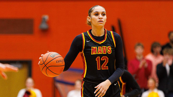 McCutcheon's Lillie Graves (12) brings the ball up the court during an IHSAA girls basketball semi-state championship game between Norwell and McCutcheon at LaPorte High School on Saturday, Feb. 21, 2026, in LaPorte.