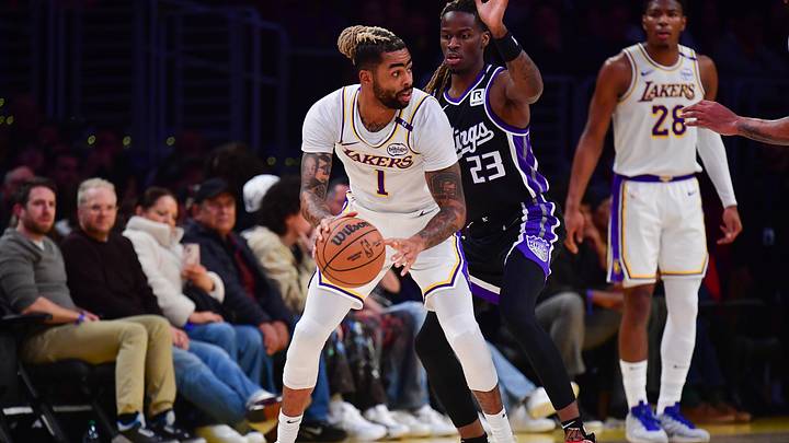 Dec 28, 2024; Los Angeles, California, USA; Los Angeles Lakers guard D'Angelo Russell (1) controls the ball against Sacramento Kings guard Keon Ellis (23) during the first half at Crypto.com Arena. Mandatory Credit: Gary A. Vasquez-Imagn Images
