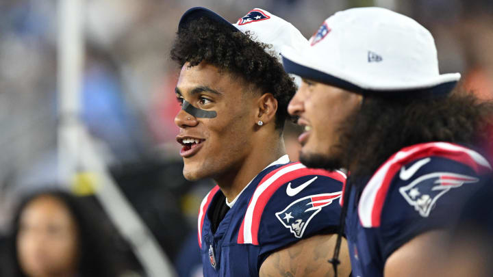 Aug 15, 2024; Foxborough, Massachusetts, USA; New England Patriots cornerback Christian Gonzalez (0) watches a game from the sidelines during the first half against the Philadelphia Eagles at Gillette Stadium. Mandatory Credit: Brian Fluharty-USA TODAY Sports