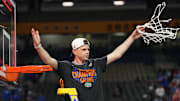 Apr 7, 2025; San Antonio, TX, USA;  Florida Gators head coach Todd Golden cuts down the net after defeating the Houston Cougars in the national championship game of the Final Four of the 2025 NCAA Tournament at the Alamodome. Mandatory Credit: Robert Deutsch-Imagn Images