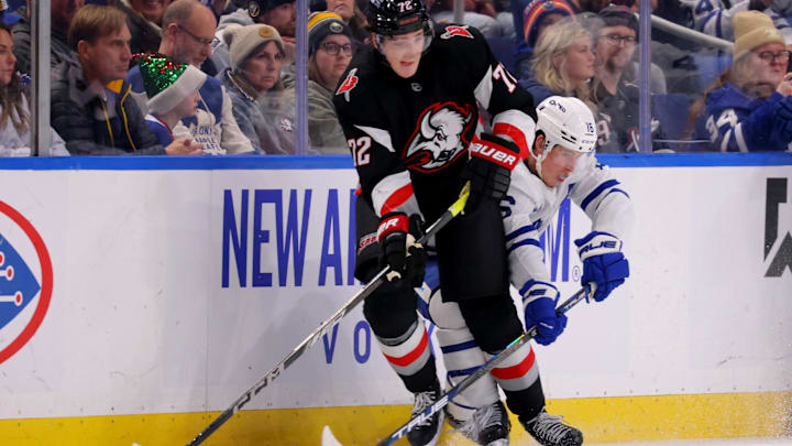 Dec 20, 2024; Buffalo, New York, USA;  Buffalo Sabres center Tage Thompson (72) controls the puck as Toronto Maple Leafs right wing Mitch Marner (16) defends during the third period at KeyBank Center. Mandatory Credit: Timothy T. Ludwig-Imagn Images