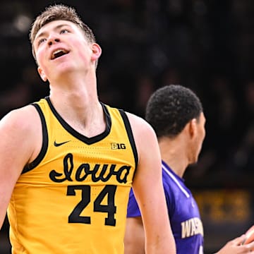 Feb 22, 2025; Iowa City, Iowa, USA; Iowa Hawkeyes forward Pryce Sandfort (24) reacts during the first half against the Washington Huskies as guard Brock Harding (2) looks on at Carver-Hawkeye Arena. Mandatory Credit: Jeffrey Becker-Imagn Images